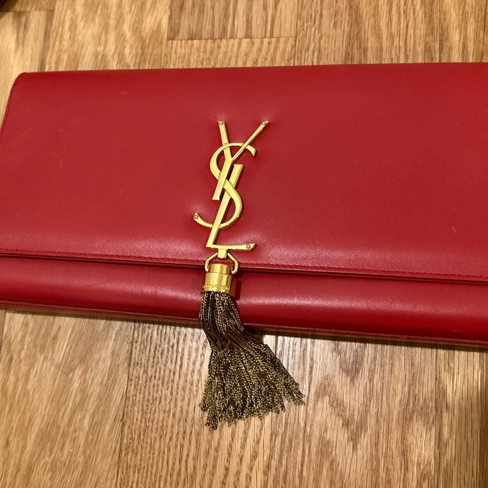 Red YSL clutch with gold hardware. Used.